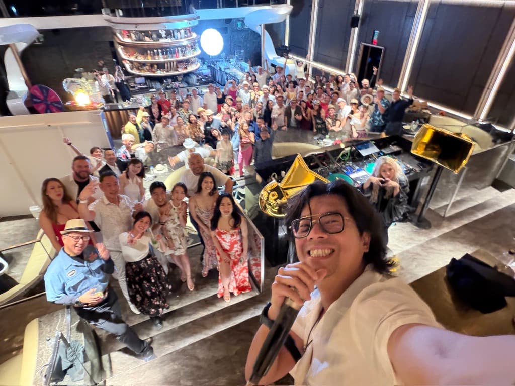 W. Michael Hsu with a microphone in front of a packed room